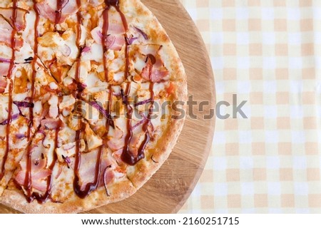 Pizza with bacon and tomato sauce from a wood-burning oven. Food photography, top view.