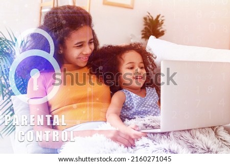 Cute girls with laptop at home. Concept of parental control