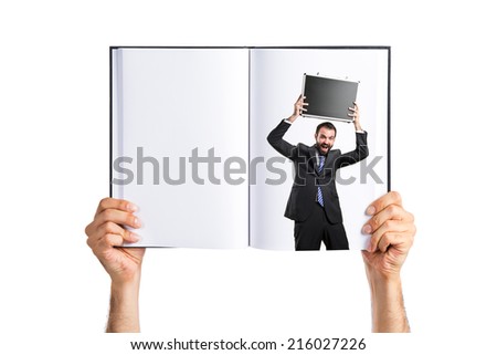 Young businessman with his briefcase printed on book