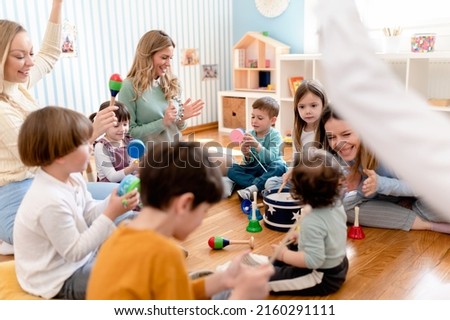 Parents taking part in the activities for preschool children. Healthy learning environment. Teacher and parents working together. Royalty-Free Stock Photo #2160291111