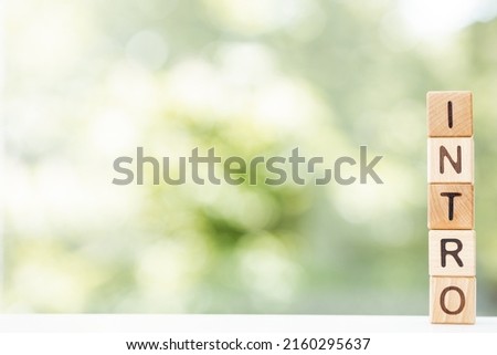 Intro on wood block. Intro green summer background for your design Royalty-Free Stock Photo #2160295637
