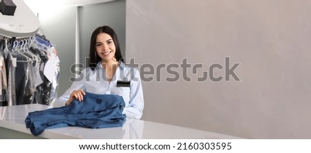Female worker with clothes, banner design. Dry-cleaning service Royalty-Free Stock Photo #2160303595