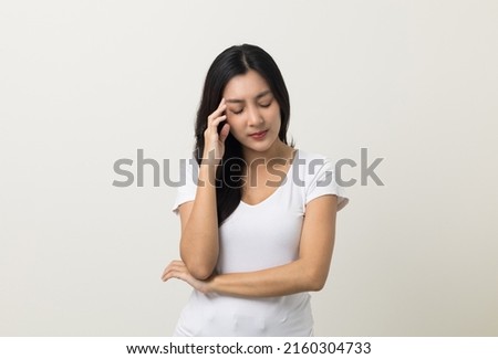 Young asian beautiful woman hand touching head she's feeling depressed stress headache be tired from working standing on isolated white background she has symptom office syndrome. Royalty-Free Stock Photo #2160304733