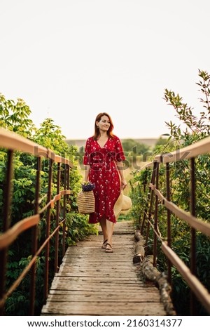Woman in red dress enjoying nature. Nature therapy, ecotherapy, practice of being in nature to boost growth and healing, mental health. Connecting with nature benefits mental health.