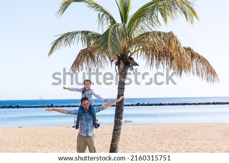 Father and Daughter playing at the beach