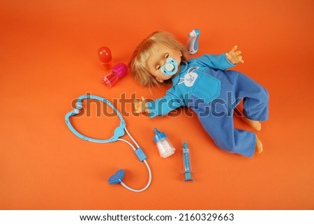 doll and medical instruments on the floor