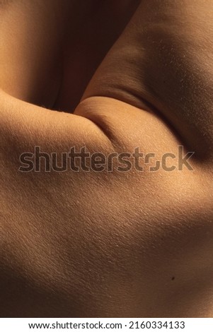 Hand and shoulder. Closeup part of woman's body. Skincare, healthcare, hygiene and medicine concept. Macro photography. Art, natural beauty concept. Design for abstract artwork, picture, poster