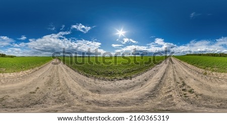 full seamless spherical hdri 360 panorama view on no traffic gravel road among fields in summer day with awesome clouds before storm in equirectangular projection, ready for VR AR