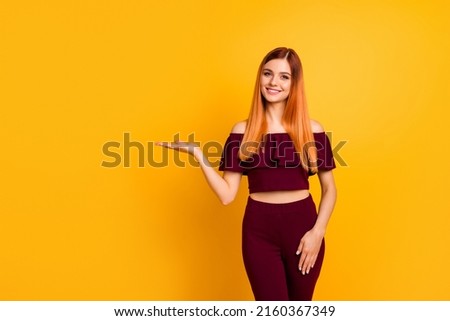Photo of gorgeous positive person hand palm hold demonstrate empty space isolated on yellow color background