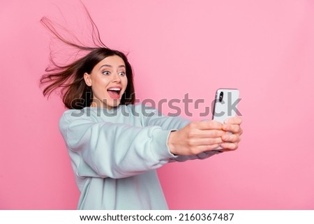 Profile side photo of young excited lady have fun make selfie vlogger isolated over pink color background