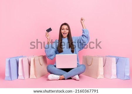 Full length photo of young lady shop rejoice success discount sit floor use laptop isolated over pink color background