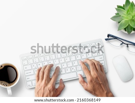 Hands typing on computer keyboard over white office desk table with cup of coffee and supplies. Top view with copy space, flat lay. Royalty-Free Stock Photo #2160368149