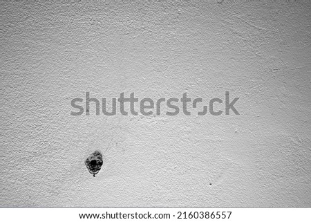 Hole and dowels in an old dirty white wall. Dowel pin inside old peeled wall for different editing projects
