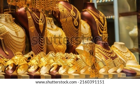 A showcase which is decorated with golden jewelleries in a shop    Royalty-Free Stock Photo #2160391151