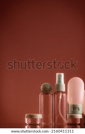 Means for face and body care. A complex of organic care products. Bottles for the transportation of cosmetics traveling by plane. Brown color scheme.