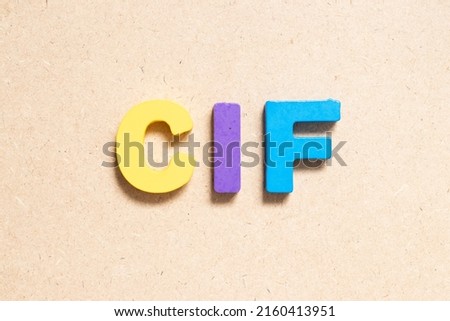 Color alphabet letter in word CIF (Abbreviation of Cost, insurance, and freight) on wood background