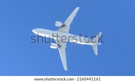 Comercial airplane flying over the sky Royalty-Free Stock Photo #2160441161