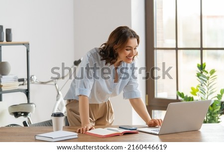 Happy young woman working, watching webinar, podcast on laptop, having remote conversation.