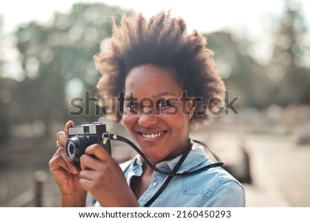 woman takes a picture with a  old camera