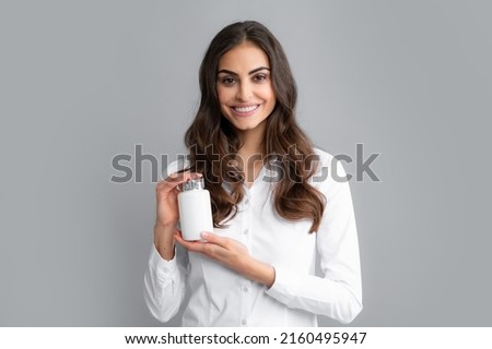 Woman with bottle pills. Happy young African American woman holding bottle of dietary supplements or vitamins in her hands. Healthy lifestyle concept. Royalty-Free Stock Photo #2160495947