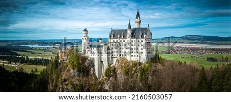 Panorama of the German castle Neuschwanstein. Beautiful Neuschwanstein castle in Germany. Fairytale Neuschwanstein castle panoramic landscape Royalty-Free Stock Photo #2160503057