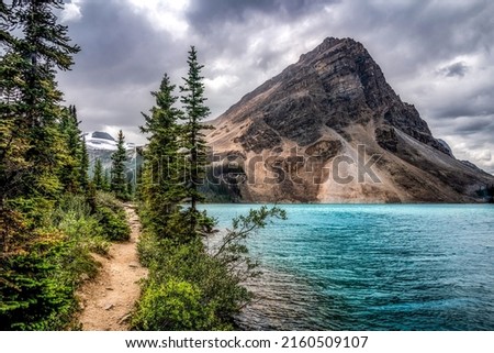 The path by the mountain lake. Beautiful mountain lake view. Lake in mountains. Mountain lake water landscape Royalty-Free Stock Photo #2160509107
