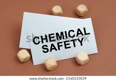 The concept of industrial safety. On a brown surface, wooden cubes and a business card with the inscription - Chemical Safety