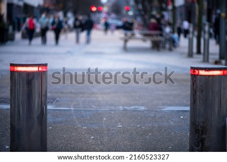 Luminous metal barriers closing the entrance to the street, hydraulically controlled