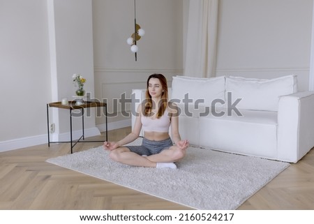 Yoga meditation. Girl practices yoga at home.