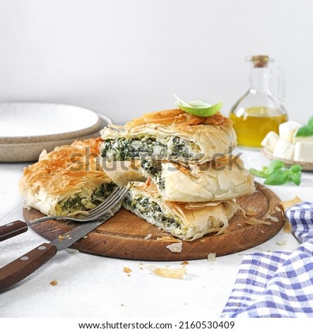pieces of Spanakopita. Classic Greek Dish.Filled with mixture of spinach, feta cheese, chopped onion, garlic, fresh herbs baked to golden