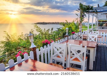 Seaside landscape - the cafe on the embankment view of the Old Town of Nesebar, in Burgas Province on the Black Sea coast of Bulgaria Royalty-Free Stock Photo #2160538651