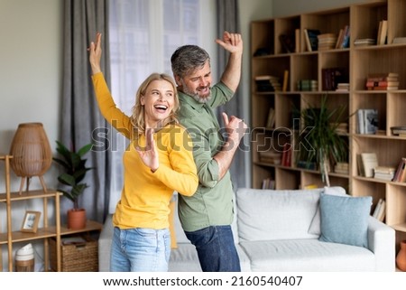 Positive Middle Aged Couple Dancing In Living Room Interior, Romantic African American Spouses Having Fun Together And Laughing, Mature Husband And Wife Enjoying Spending Time At Home, Copy Space
