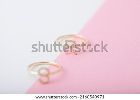 Diamond rings on pink and white background. Jewelry image for e-commerce, online selling and social media.