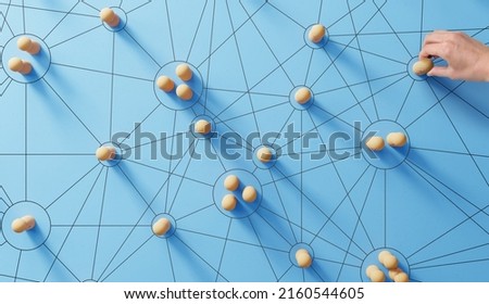 Social media networking. Network with members connected with each other. Group of people. Communication, teamwork, community, society. Abstract concept with wooden pieces on blue background. Royalty-Free Stock Photo #2160544605