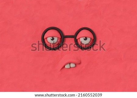 Nerd monster with glasses, fabulous creature made by hand from pink plasticine. Comic facial expressions. Ugly and crazy face of alien monster. 3d artwork Royalty-Free Stock Photo #2160552039