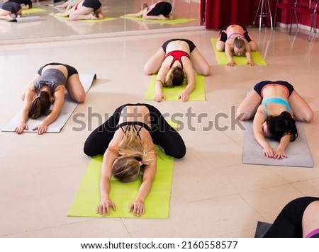 women develop flexibility in training on yoga in the room