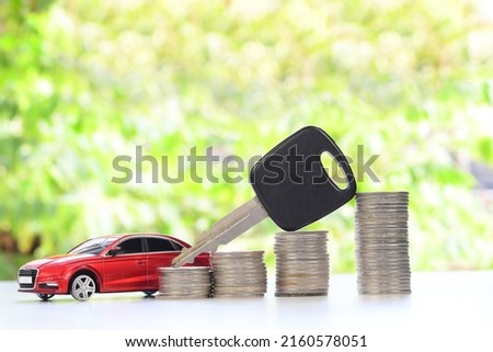 Car and key on stacks of coin, car loan concept, Saving money for car concept, trade car for cash concept, Investment and business concept