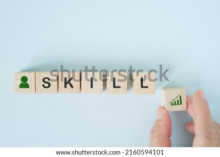 SKILL word on wooden cube blocks with senior's hand holding increasing percent, improving, learning many skills for advancement