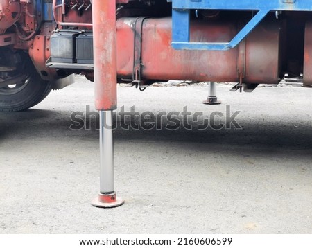 Photo of hydraulic support on lorry crane. Selective focus.