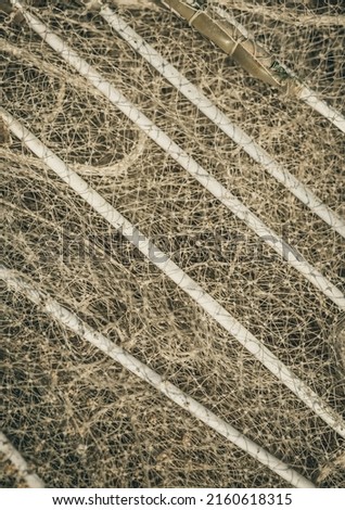 VERTICAL abstract close macro real photo beautiful wallpaper. Fisherman rope net texture fiber surface pattern. Sea blue green light colour. Futuristic subtle waving lines art modern. Pale background