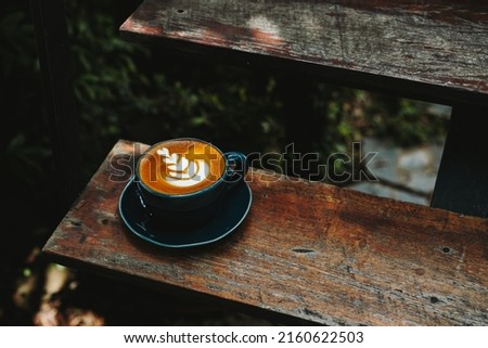 Early Morning Coffee,coffee latte art on the wood,Natural Dark Food Photography Latte Art in vintage color tone.