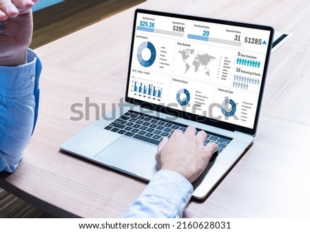Businessman hand on keyboard laptop with mockup chart presentation slide show on display