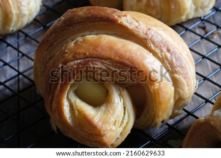 Closeup of croissants on a cooling rack. croissant, which originated in France, is so named because of its shape resembling a crescent moon. made from wheat, eggs, salt, margarine. Cheese croissant. 