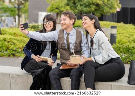 coworkers taking a selfie at break outdoors, multiracial business colleagues making video call outdoors