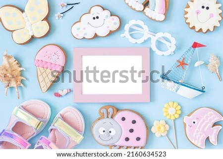 Bright creative layout made of white blank frame and cute summer symbols on pink background. Copy space, Top view, Flat lay. Mock up. Creative summer concept.