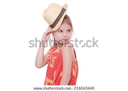 Caucasian little girl in summer dress and straw hat
