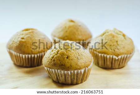 Banana cup cake isolated on wooden Background.