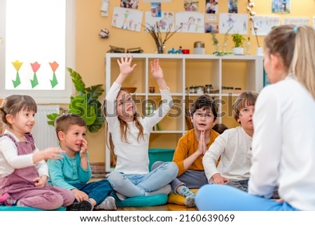 Active preschool Children Interacting with their Teacher. Teacher-child relationships – Early Learning.  Healthy Learning Environment Royalty-Free Stock Photo #2160639069