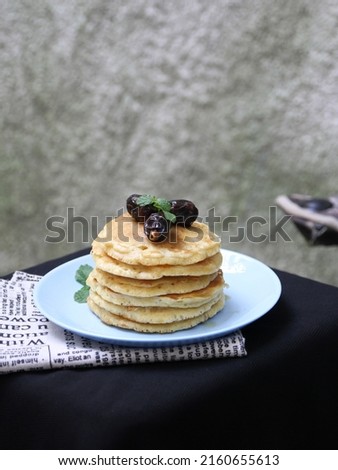 Pancakes are made from flour, eggs, liquid milk, baking soda and sugar mixed together.
Cooked on a pan and ready to be served with various toppings. the picture is topped with dates and honey.