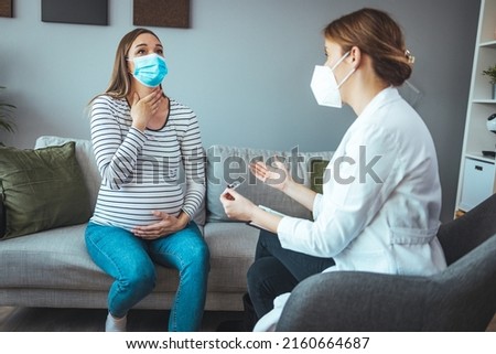 A pregnant woman holds a thermometer for temperature. Influenza treatment. Sick female at home. Health protection. Check for infection. Use a face mask to protect against viruses